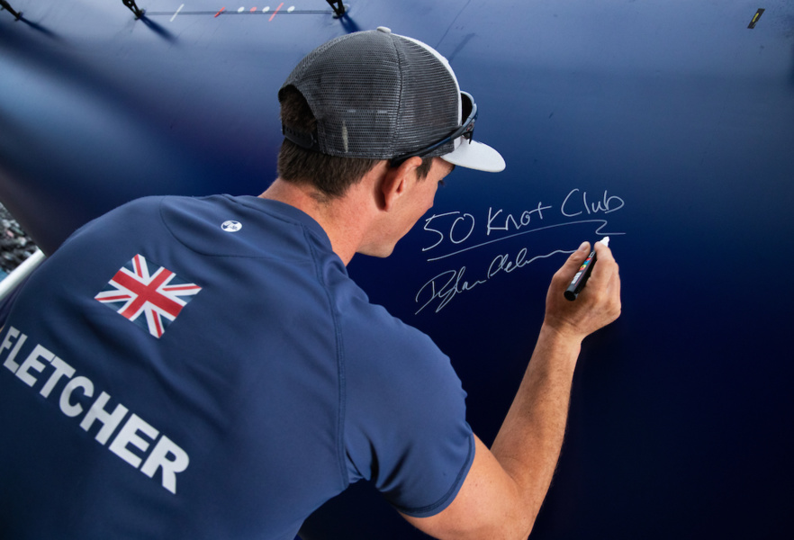 Briton Dylan Fletcher signs his catamaran after being officially registered at practice to 50.22 knots.