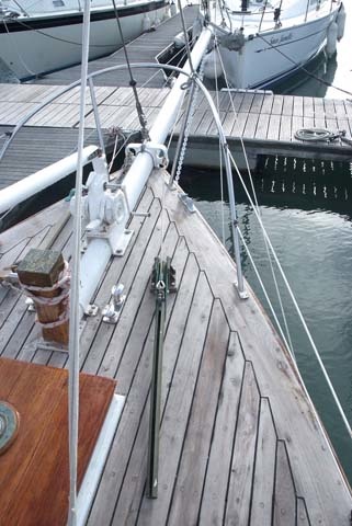 The original Highfield bronze lever at the bow allows you to release the forestag and clipper halyard long enough to pull the sail aboard and unhook it from the focus rod so you don't have to climb the bowsprit. 