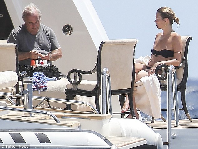 Philip Greene aboard the Lioness V with supermodel Kate Moss.