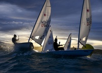 «The day was almost over, the results of the last Italia Cup #7 regatta in the Laser class were discussed. The light of the November day was gradually fading. We were on our feet all afternoon, everybody was tired, but the golden light that preceded the sunset created a magical atmosphere in the racing zone. I think this photo, taken behind the top sign, conveys the energy, tension and drama of the last minutes of the regatta»,