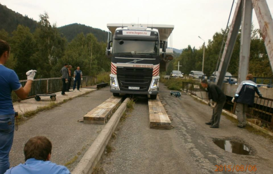 Laying wooden decking under a tractor.