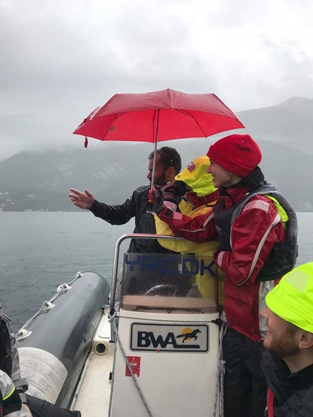 Elena Otekina (in yellow raincoat) takes pictures in any weather.