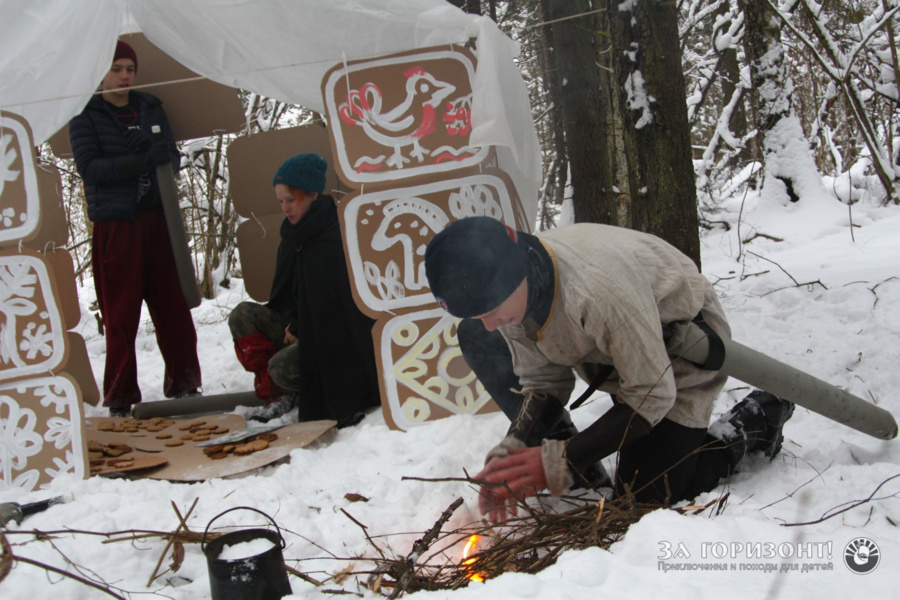 Participants of a one-day New Year's Eve game on December 30, 2018 make a fire to warm up the glaze and paint cakes.