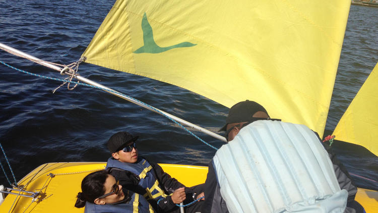 Ridge Beecher, a 19-year-old participant in the program, goes swimming for the first time without an instructor. Lisa Letren from the Baltimore Police Department is on board with him - her first sailing experience. 