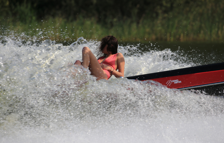 In a swimsuit and without a helmet on a wake-up call, a girl can only be aboard a towboat.