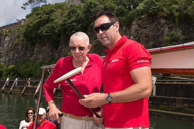 Bob Otlie transmits the Wild Oats mascot, a cane with a boat hull-shaped top, to skipper Mark Richards.