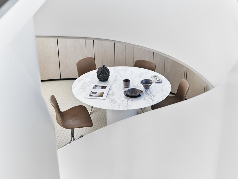 Next to the galley, there's another table hidden behind the spiral staircase on the main deck of the SX76.