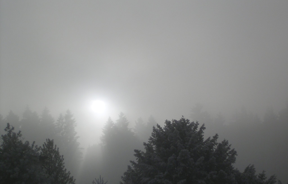 The sun shines through the layered clouds