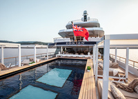 A huge pool is another feature of Lonian. It is remarkable not because of its size, but because its transparent glass bottom is also the ceiling of the beach club.