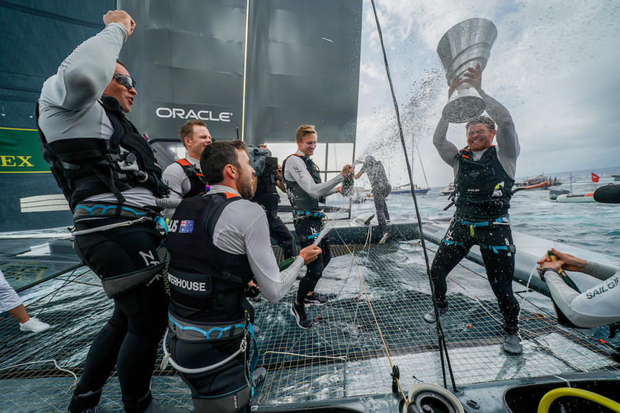 Australian team celebrates victory aboard their catamaran.
