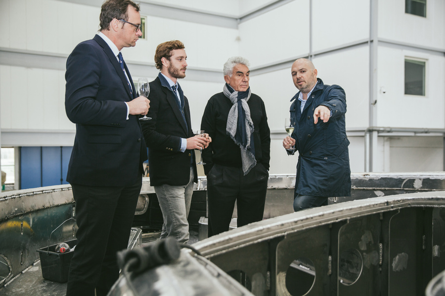 Sergei Dobroserdov (right) shows Dynamiq to Pierre Kaziragi (second left) and Bernard D'Alessandry, Secretary-General of the Yacht Club of Monaco (second right).
