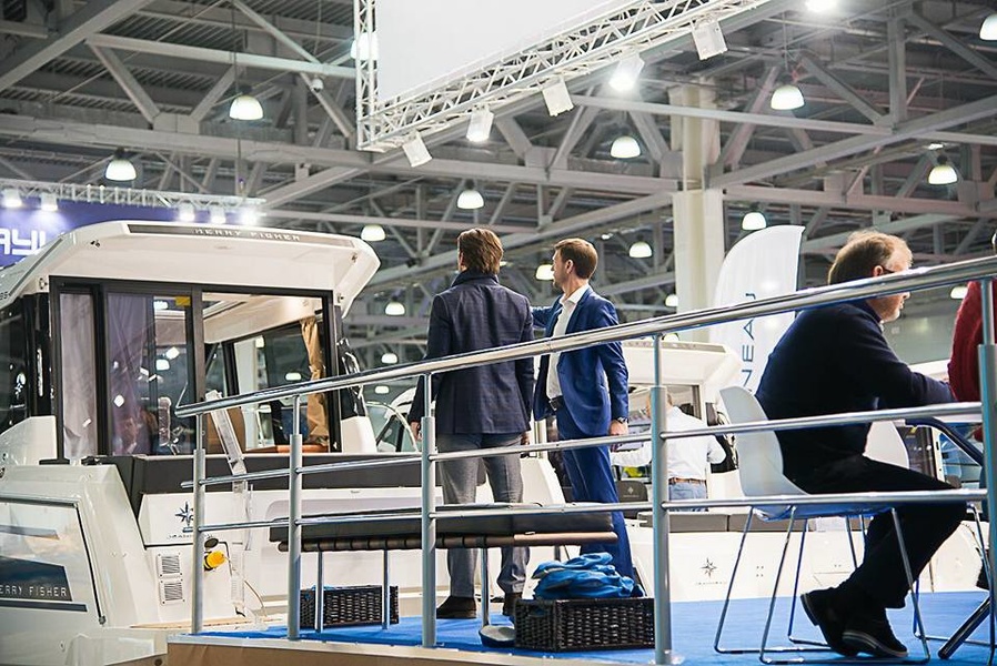 A visitor of the Moscow Boat Show admires Jeanneau Merry Fisher at the Prestige Yachts booth while waiting for the election results.