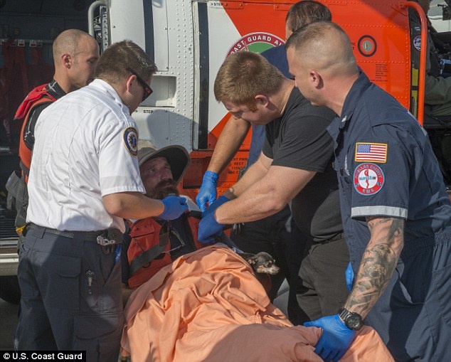 Rescuers are examining the man and his companion.